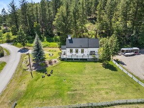 A large house with a spacious lawn, a boat dock, and a fenced area. - Smith`s Church House | 1903 | Fireplace | Iconic (Wilmer)