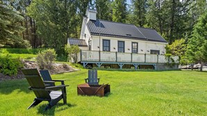 A house with a porch, a lawn, and two Adirondack chairs. - Smith`s Church House | 1903 | Fireplace | Iconic (Wilmer)