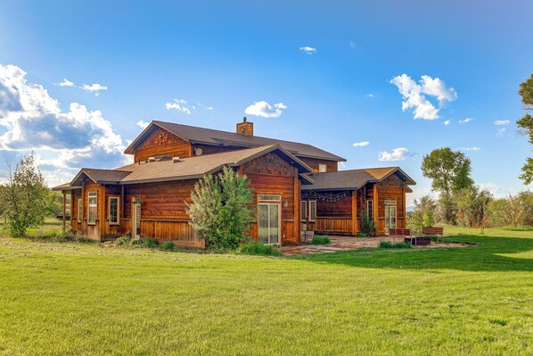A large wooden house with a spacious front yard and a clear blue sky. - Spacious Afton Home: Patio, Grill & Mountain Views (Afton)