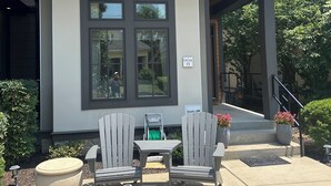 A modern building with a covered patio area featuring outdoor seating and a fire pit. - Great Location!  Charming 3-bedroom townhome in brilliant Nashville w/ AC, WiFi (Nashville)