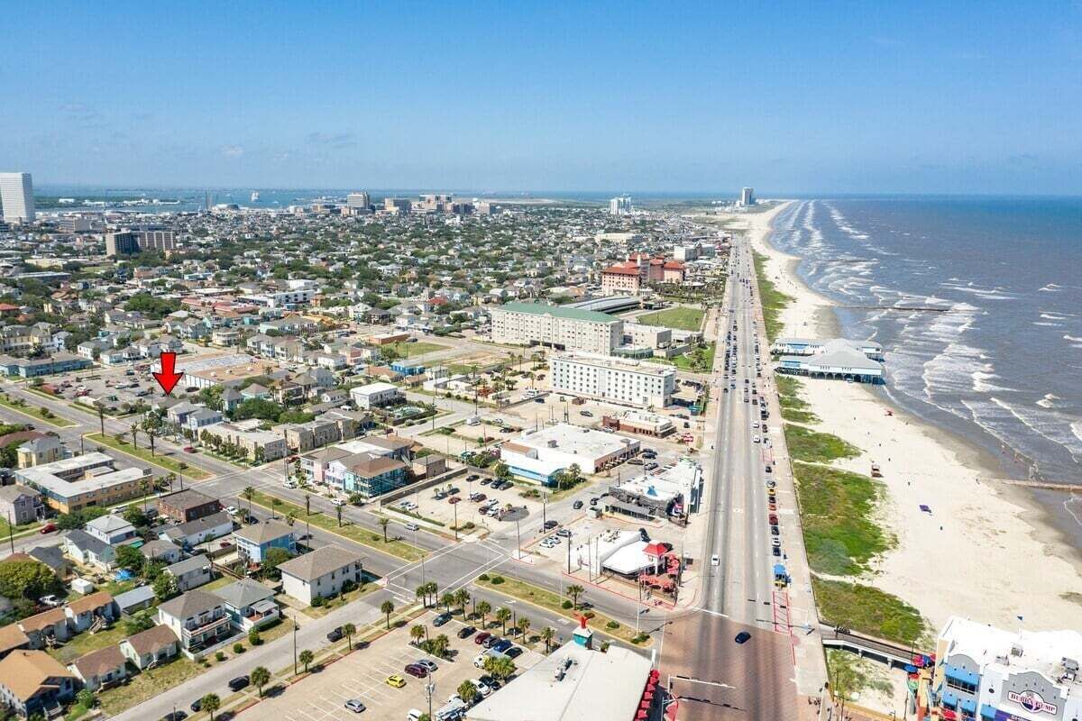 A coastal cityscape with a beachfront, roads, and buildings.