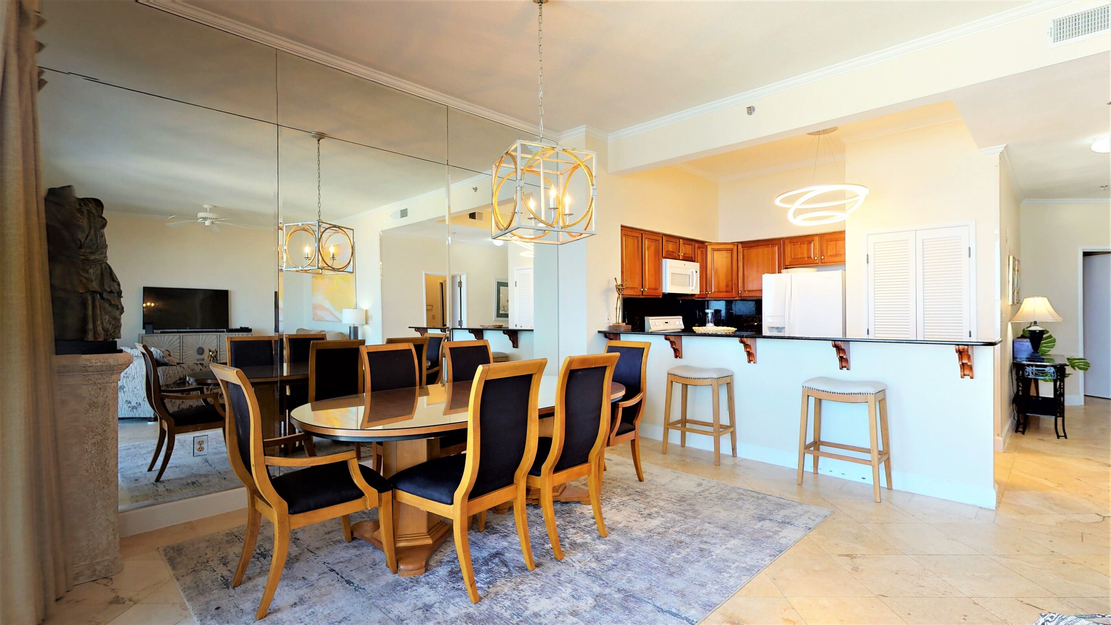 A modern kitchen with wooden cabinets, a built-in microwave, and a refrigerator.