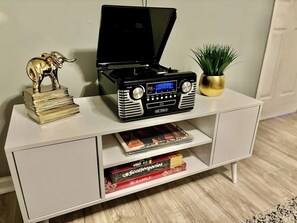 Enjoy entertainment and leisure in this cozy room with a flat-screen TV, board games, and a potted plant.