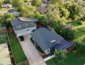 A residential property with a detached house, a garage, and a driveway.