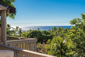 A balcony with a view of the ocean and tropical vegetation. - Aloha Condos, Keauhou Resort, Condo 111, Ocean View (Kailua Kona)