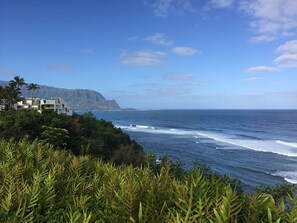 Eine Küstenansicht mit einem Gebäude auf einer Klippe mit Blick aufs Meer.