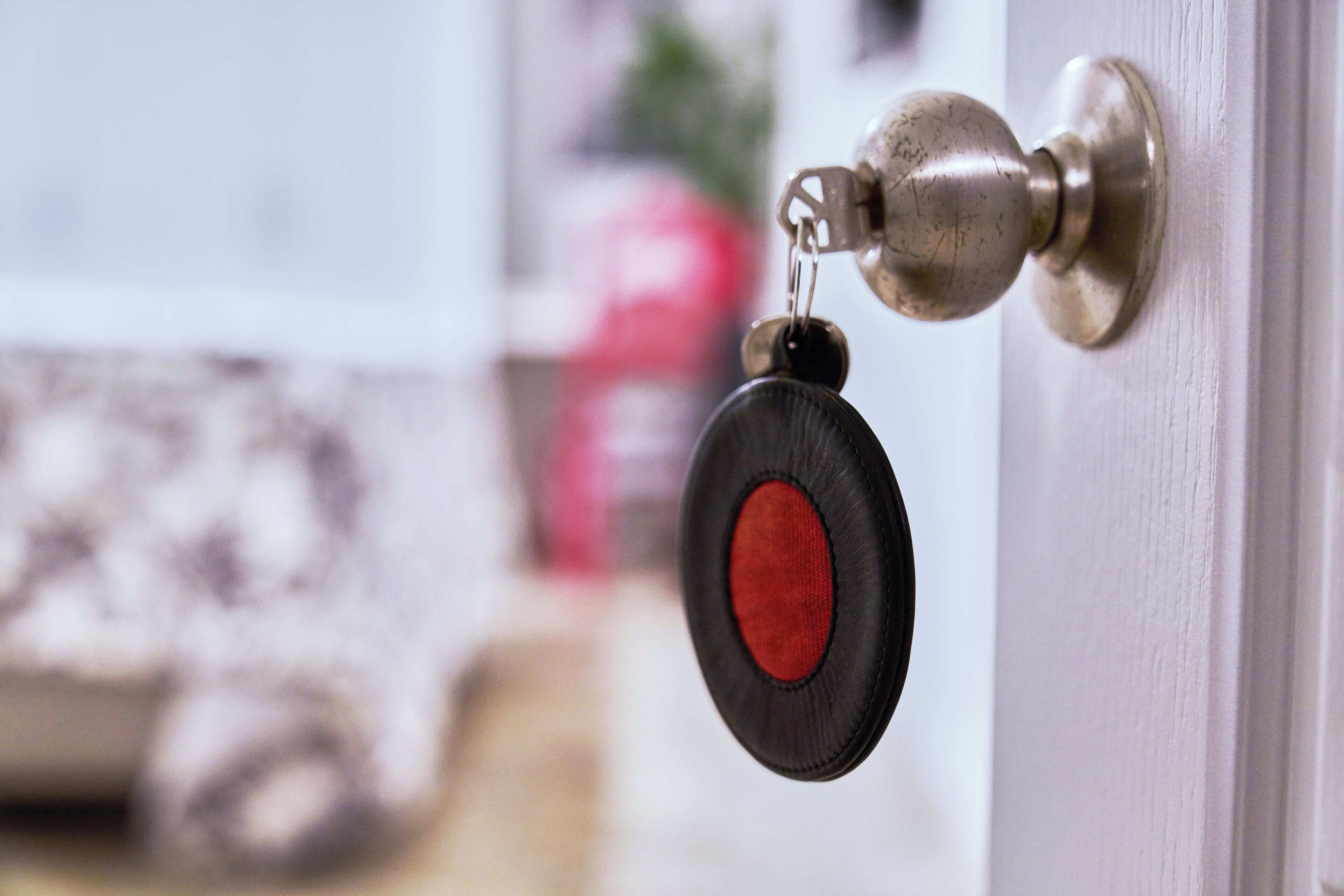 A door with a keyhole and a keychain with a key.