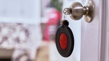 A door with a keyhole and a keychain with a key.