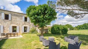 A stone building with a tree in the yard, outdoor furniture, and a clear sky. - Holiday Home 'Maison De Vacances Avec Piscine' with Private Pool, Private Terrace and Wi-Fi (Sainte-Gemme)