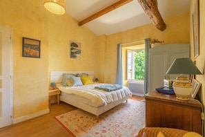 A bedroom with a bed, nightstands, a dresser, a lamp, and a window with curtains. - Holiday Home 'Maison De Vacances Avec Piscine' with Private Pool, Private Terrace and Wi-Fi (Sainte-Gemme)