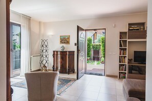 Apartment, Garden View | Living area | 32-inch TV with digital channels