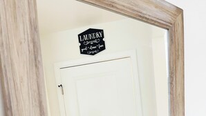 Una puerta blanca con un letrero encima que dice 'LAUNDRY good clean fun'.