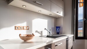 A modern kitchen with a wooden countertop, a sink, and a window with a view. - Apartment 'Annecy - Le 10' with Balcony, Wi-Fi and Air Conditioning (Annecy)