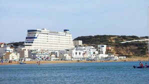 A coastal hotel with a large building, beach access, and a view of the sea. - CTM - Le Bateau (Terga)