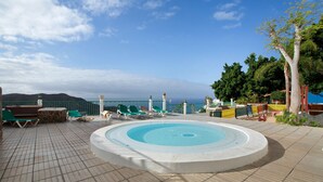 A pool area with a circular design, lounge chairs, and a view of the sea. - Vacation Apartment 'Francesco House 1509 Monte Paraiso' with Sea View, Wi-Fi and Air Conditioning (Puerto Rico de Gran Canaria)