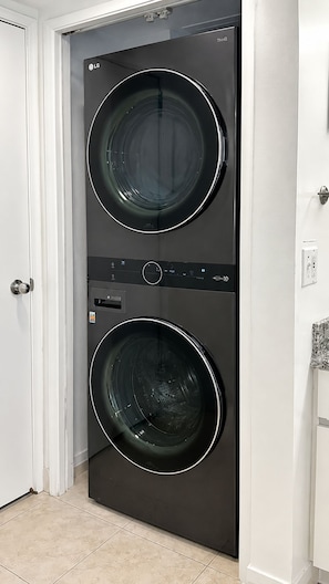 A double-door laundry room with a modern design, featuring two front-loading washing machines.
