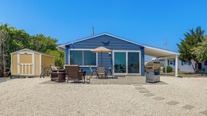 A two-story house with a covered patio, outdoor seating, and a barbecue grill. - Little Egg Harbor Township Retreat w/ Private Dock (Little Egg Harbor Township)