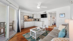 A modern apartment with a kitchen, living room, and a balcony. - 🌴BBC 214 - Gulf Front Condo - Pool & Beach are OPEN! (Belleair Beach)