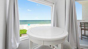 A white table on a balcony with a view of the beach and ocean. - 🌴BBC 214 - Gulf Front Condo - Pool & Beach are OPEN! (Belleair Beach)