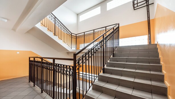 A multi-level interior with a staircase and a balcony.