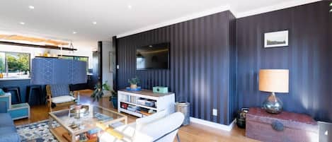 A modern living room with a sofa, coffee table, and TV.