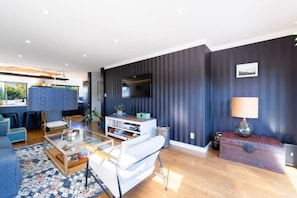 A modern living room with a sofa, coffee table, and TV.