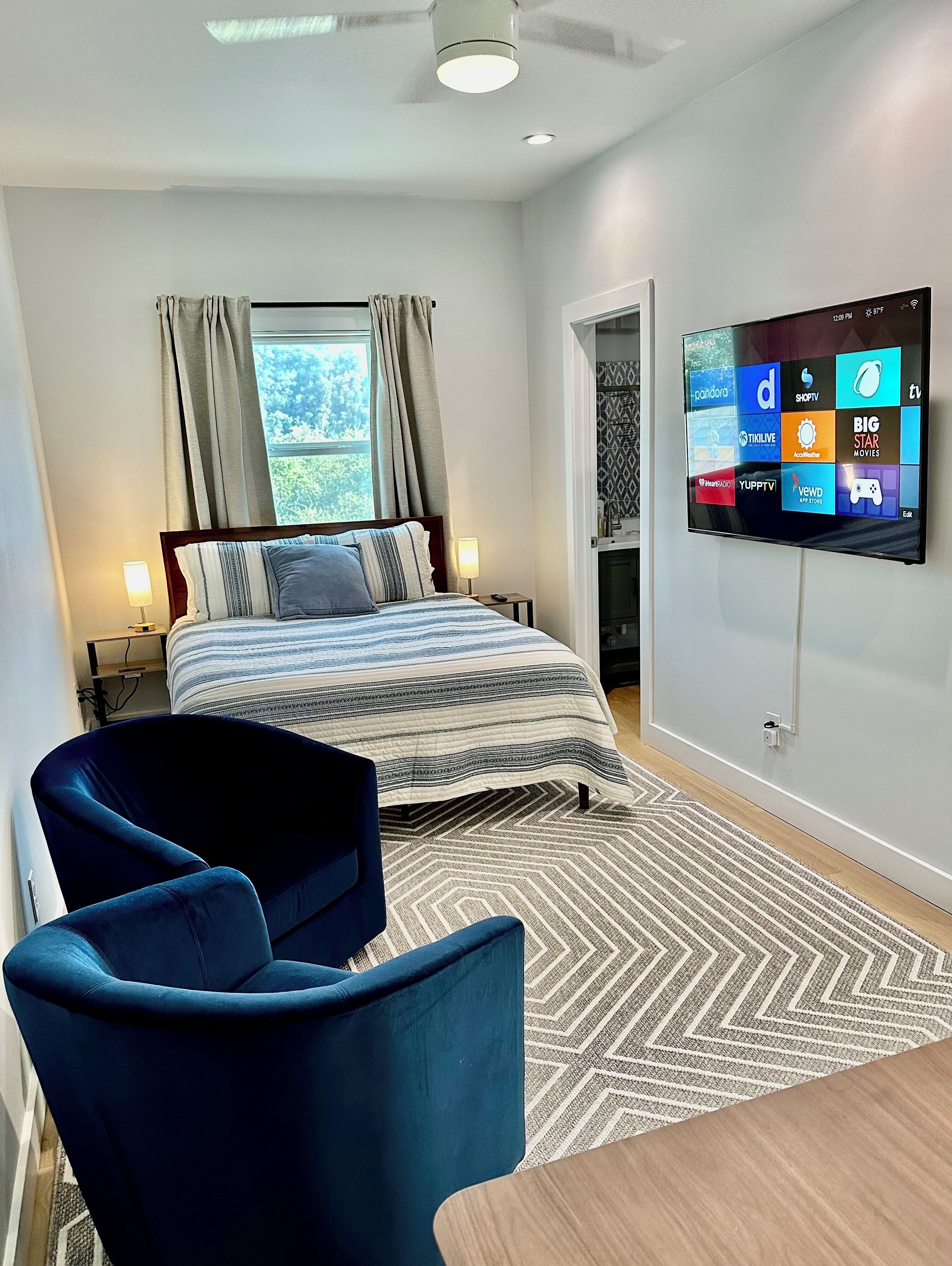 Bedroom 3 Studio - Queen Bed TV and decorative comfy chairs. 