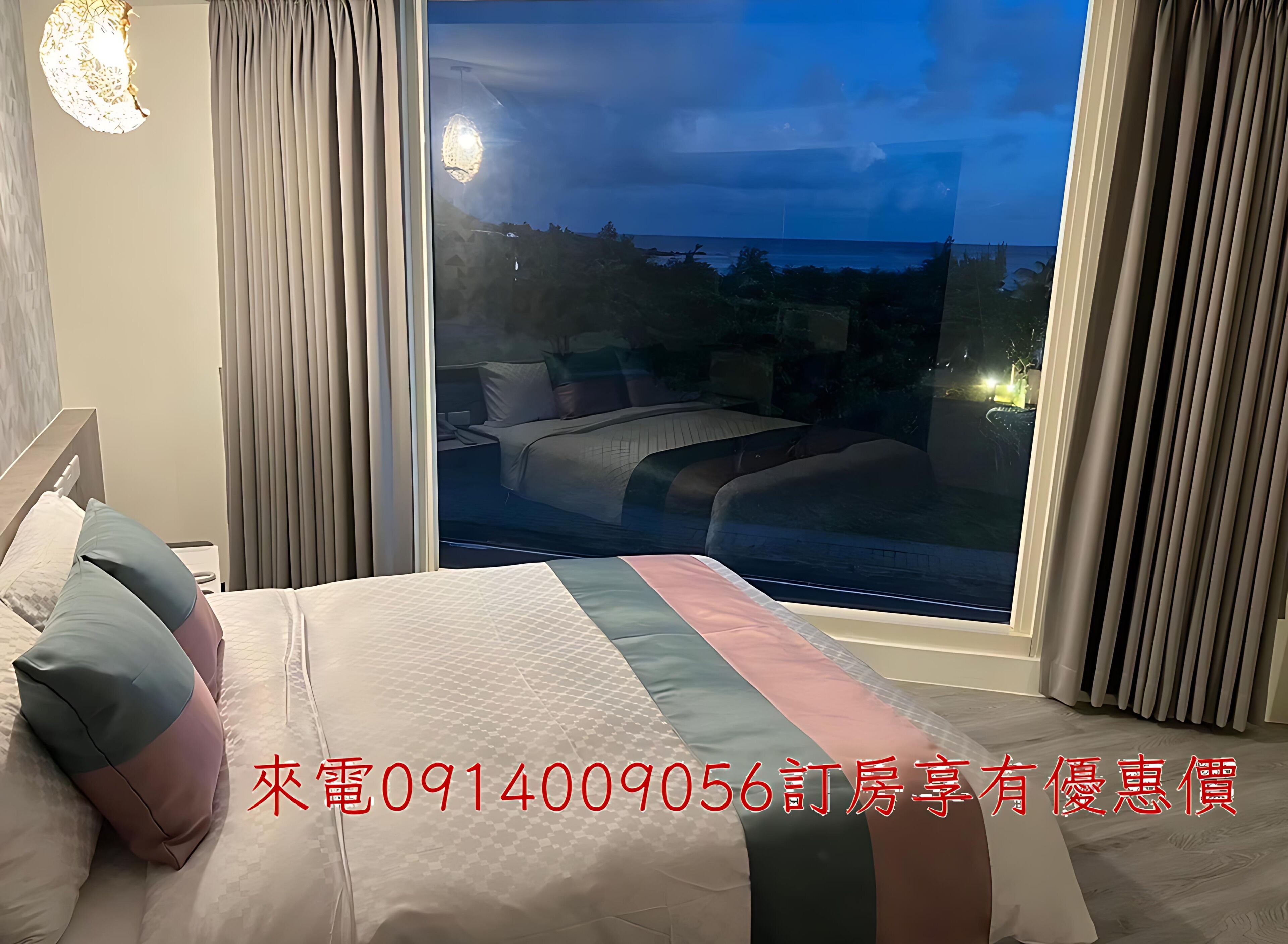 A bedroom with a large bed, a nightstand, and a window with curtains.