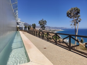 Enjoy a serene ocean view from the comfort of our hotel, where a long swimming pool and beach await.