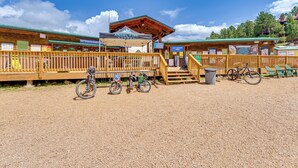 A wooden building with a covered entrance and a sign for Angel Fire Resort. - Walk to Angel Fire Lifts! Mountain-View Condo (Angel Fire)