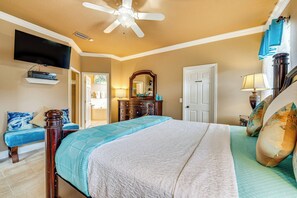 A bedroom with a bed, a TV mounted on the wall, a ceiling fan, and a dresser. - 14 Mi to Disney: Spacious Home w/ Pool & Lanai! (Davenport)