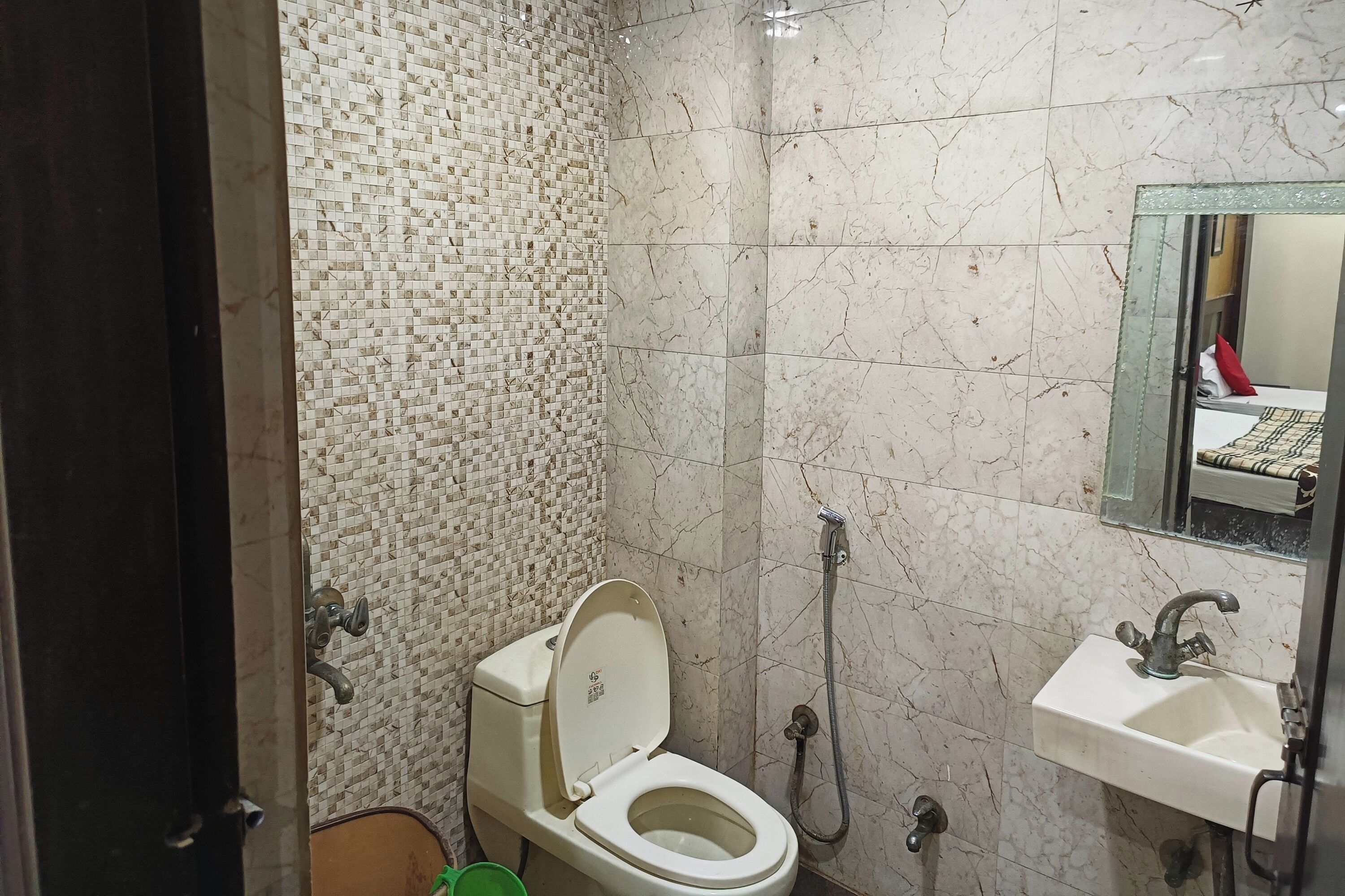 A bathroom with a toilet, a sink, and a shower.