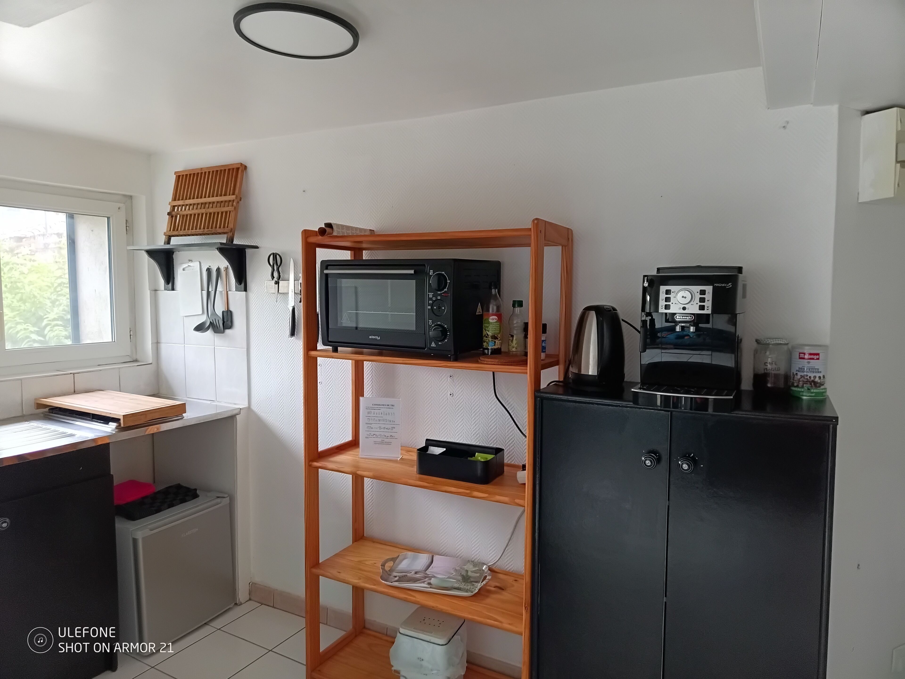 A compact kitchenette with a microwave, coffee maker, and a small refrigerator.