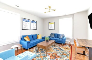 Monopoly Living Room: Relax on plush couches, catch up on work at the dedicated workspace, or unwind with our Roku TV.