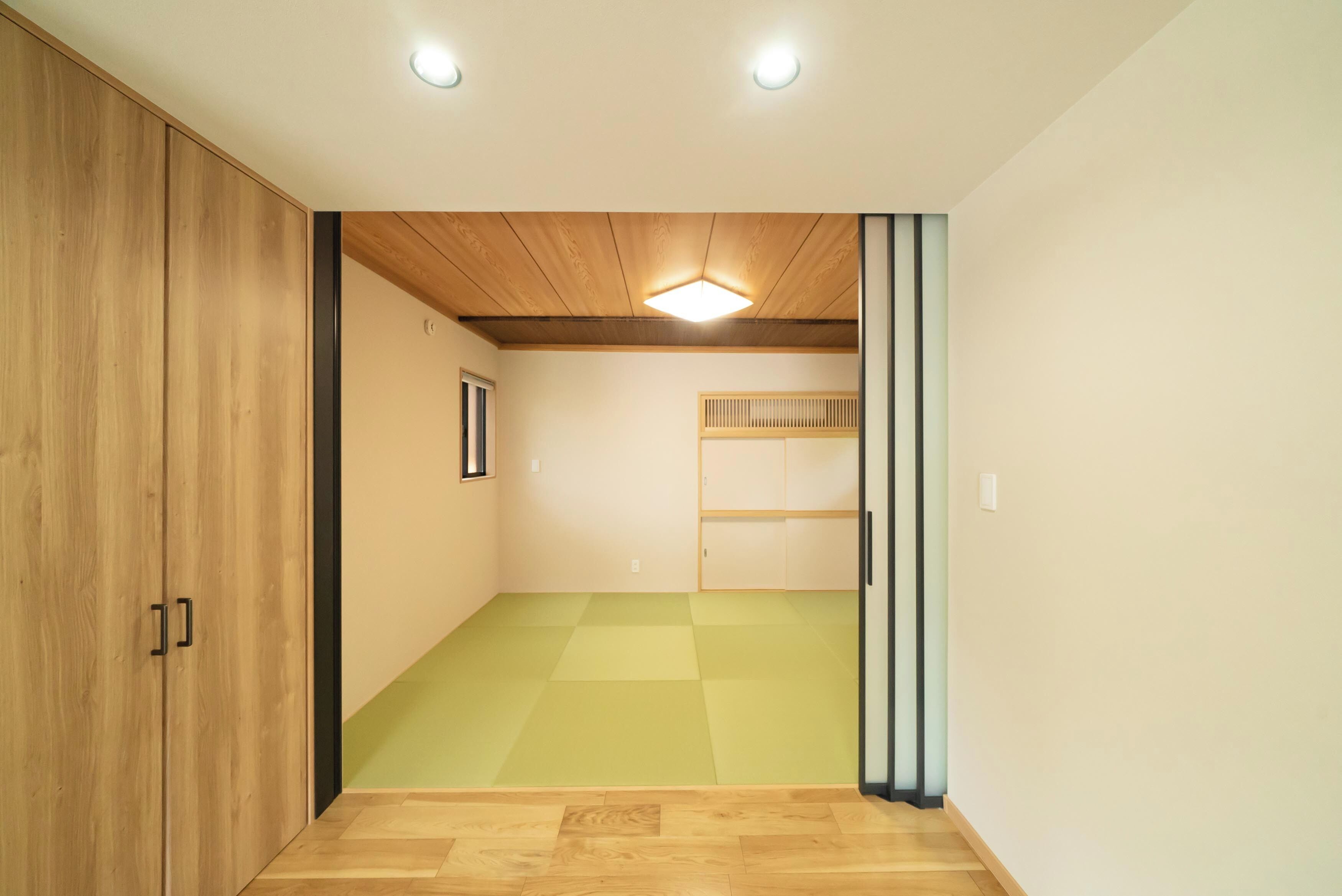 A room with wooden flooring, a sloped ceiling, and a bunk bed.