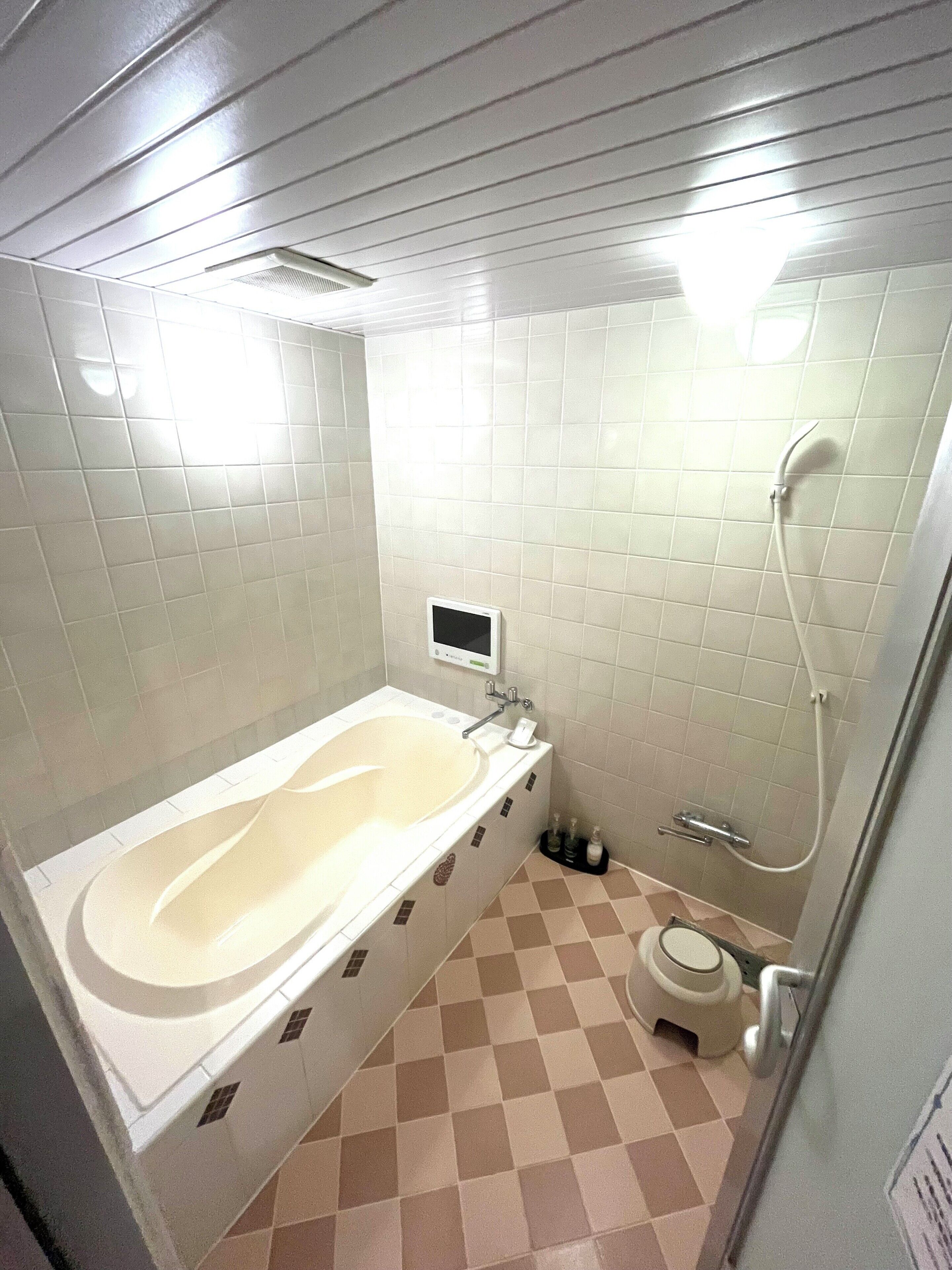 A bathroom with a bathtub, a shower, and a toilet.