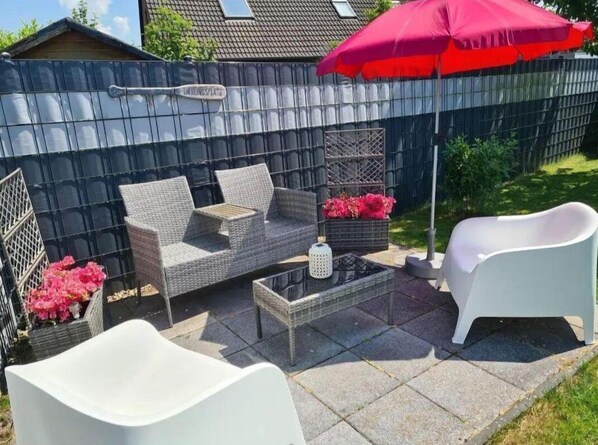 Relax in style with a sofa, armchairs, and a sculptural chair on this stylish patio.
