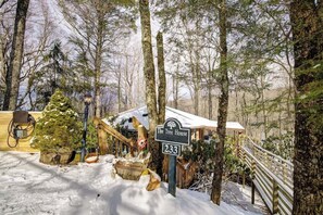 A snowy forest setting with a sign for 'The Tree House' at 233. - Cool Tree House with Hot tub  FREE EV charging (Beech Mountain)