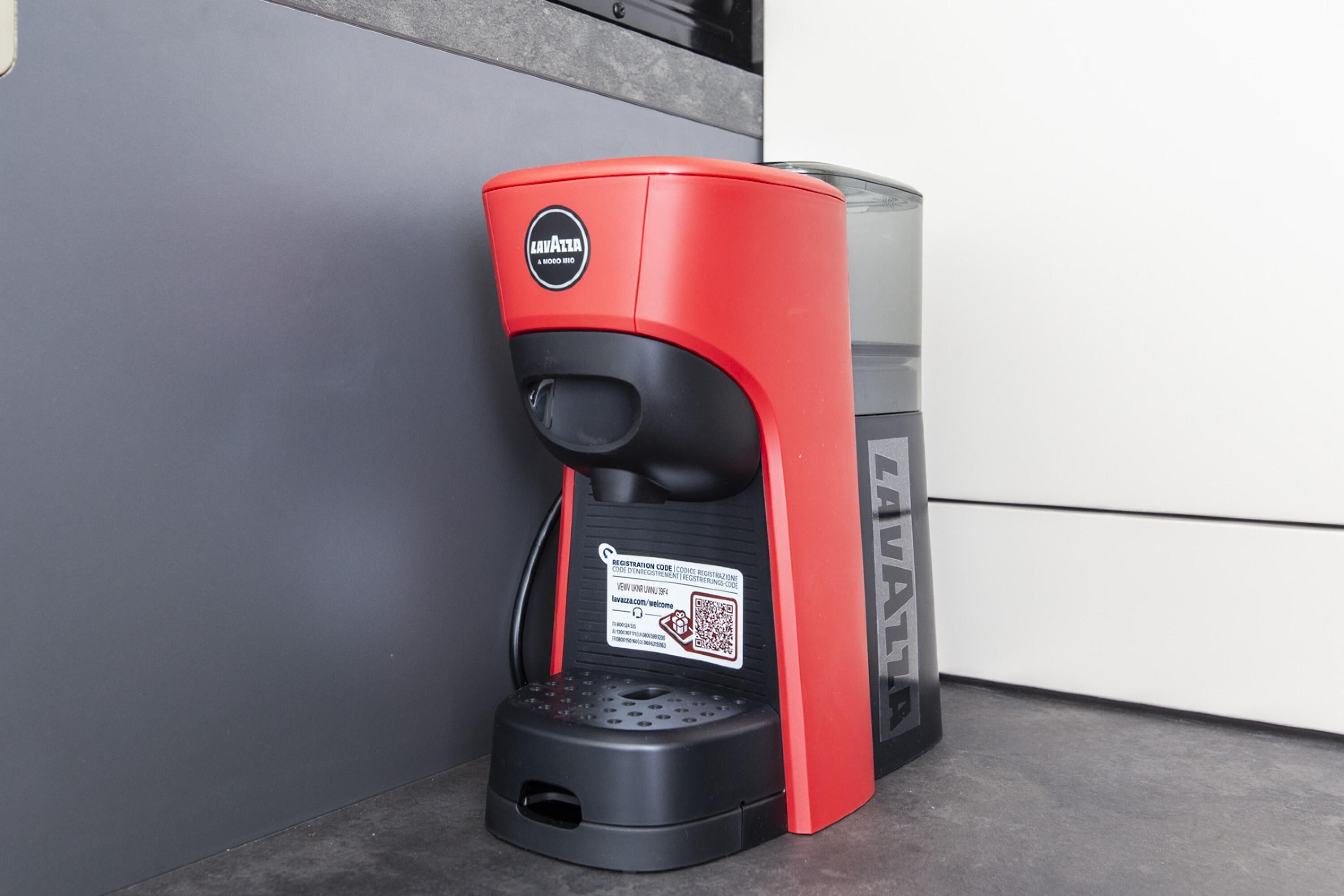 Una máquina de café roja y negra con un código QR y una etiqueta lateral.