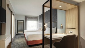 A hotel room with a bed, a desk, a chair, a TV, and a mirror. - SpringHill Suites® by Marriott® Easton Bethlehem (Easton)
