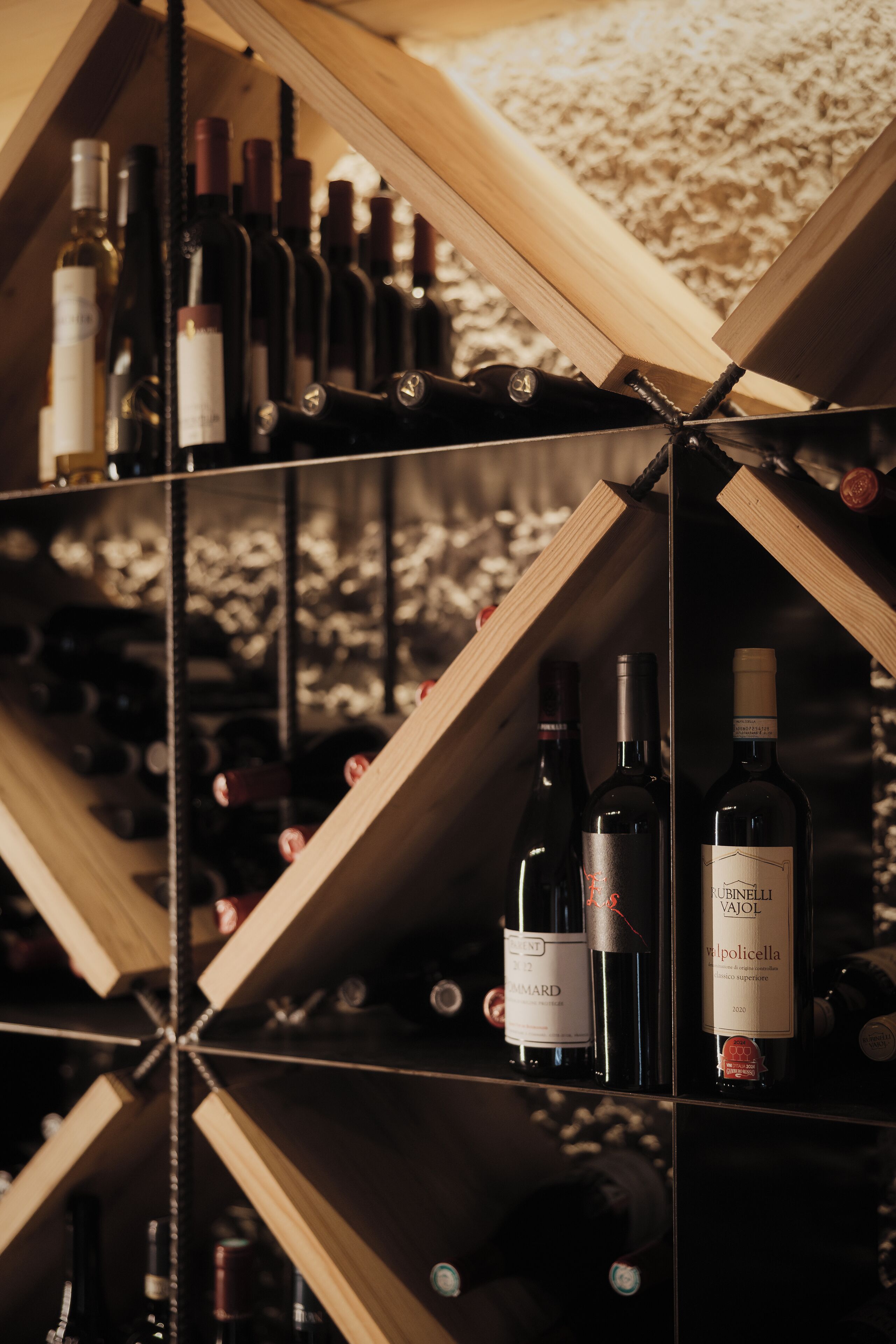 A wine rack with multiple bottles, including a 'Chandon' and 'Pollicella' wine.