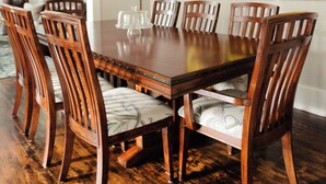 A dining room with a wooden table and chairs, a hanging light fixture, and a painting on the wall. - We can all stay together, everyone has room, the dog can come, and getting where we need to go is easy. (Montgomery)