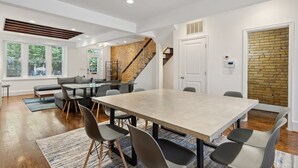 Ein modernes Interieur mit Essbereich, Treppe und Ziegelwand.