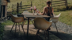 A rustic wooden table with chairs outside a stone building, set on a stone patio. - THE HAYLOFT at Sunny Brow Farm in the heart of the Lake District National Park.  (Ambleside)