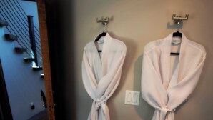 Two white robes hanging on a wall in a hallway. - The Silo Loft at Goose Lake Lane, at East Zion & Bryce Canyon National Parks (Glendale)