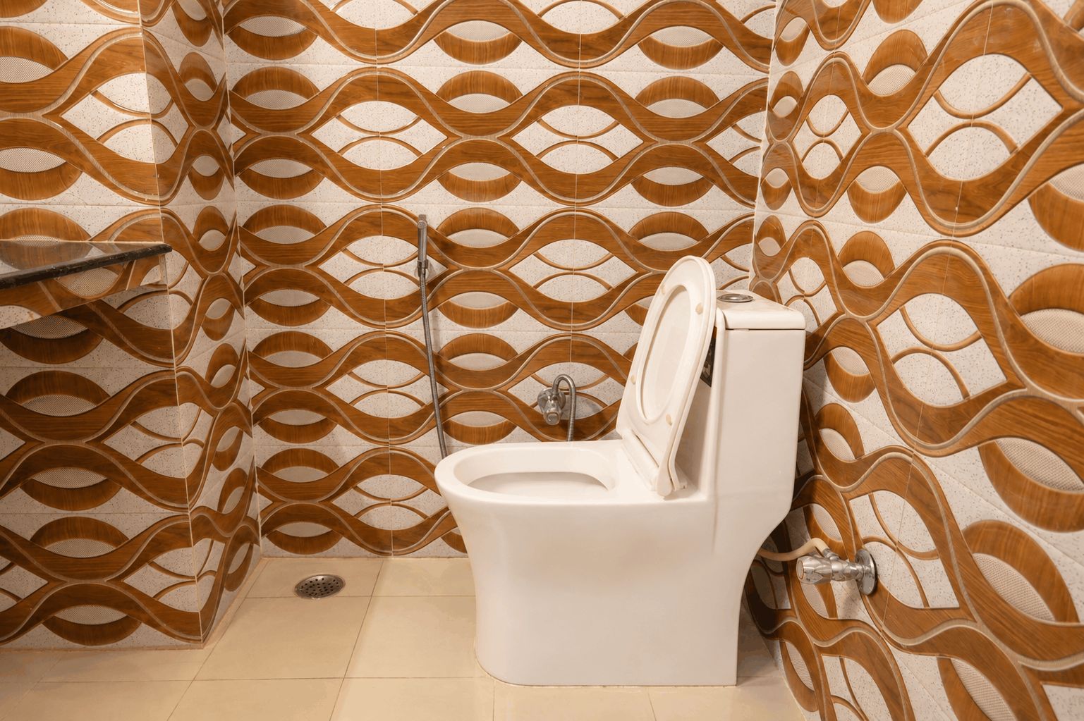 A bathroom with a toilet, a shower, and a sink.