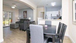 A modern kitchen with white cabinets, a black countertop, and a decorative Christmas tree. - Crescent Palms - Near Brandon, Tampa, Riverview (Tampa)