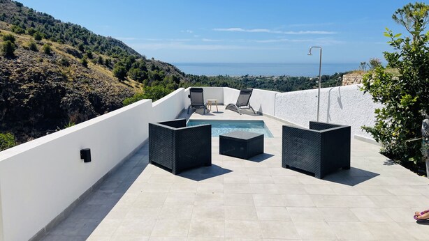 A rooftop terrace with a pool, lounge chairs, and an umbrella. - Paradise House in Frigiliana (Frigiliana)