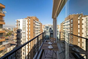 Relax on the balcony with a cup of coffee, taking in the city views.