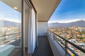 A balcony with a view of a city and snow-capped mountains. - Apartment in Las Condes: Comfort, Pool and Balcony (Las Condes)